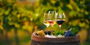 Wine glasses sitting on barrell; Winery tours are a great date idea.