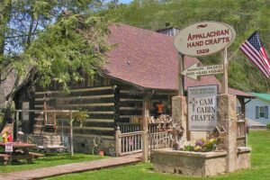 CAM Cabin Crafts is shown: a small cabin that sells handmade items. 